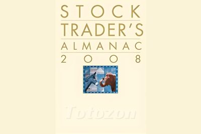 A financial trader analyzing charts and data from the Stock Traders Almanac. (2)