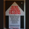 Sure-thing Options Trading by George Angell, depicting charts and options data.