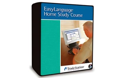 A trader using the EasyLanguage Home Study Course materials to develop trading strategies on a computer