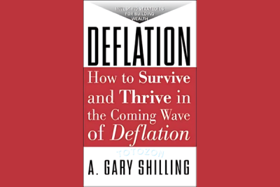 A. Gary Shilling analyzing economic data, symbolizing the study and understanding of deflation and its impacts.