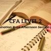 Focused analysis of CFA exam materials with charts and graphs on the table