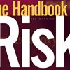 Image of Ben Warwick's The Handbook of Risk book cover on a desk surrounded by financial charts and a laptop.