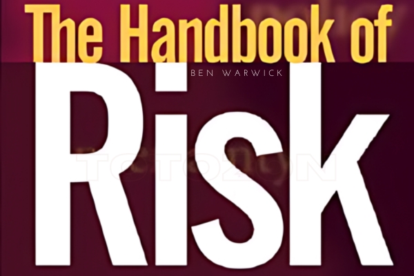 Image of Ben Warwick's The Handbook of Risk book cover on a desk surrounded by financial charts and a laptop.