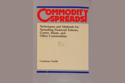 trader analyzing charts of various commodities, representing techniques for spreading financial futures, grains, meats, and other commodities