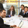 A trader participating in a day trading bootcamp with charts and graphs on the screen.