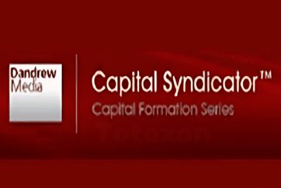 Real estate investors discussing commercial capital syndication strategies with charts and documents