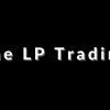 A trading desk with charts, notes, and the LP Trading Course materials, symbolizing a structured approach to consistent trading success